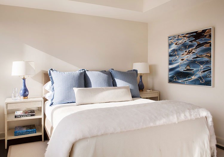 White bedroom with blue painting