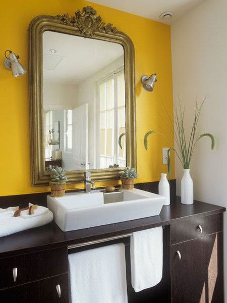 Yellow bathroom with ancient mirror