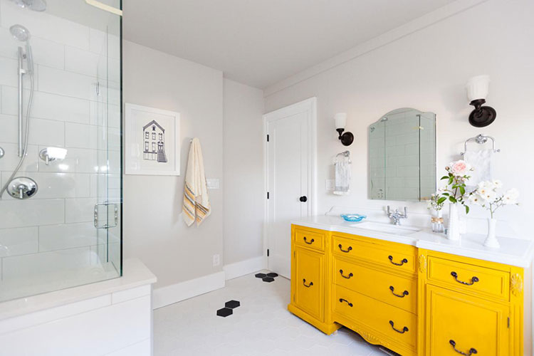 Yellow vanity in white bathroom